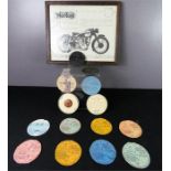 A group of tax discs for Vintage motorcycles, and a Norton Model 30-40 International.