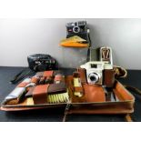 Three vintage cameras, gentleman's dress set, Polaroid sunglasses and case, travelling razor set.