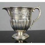 A silver fluted jug, with foliate design and engraved with Olive Mary Morgan Hawkesford, 30th