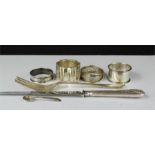 A group of silver to include napkin rings, fork, silver handled knife etc.