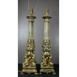 A pair of large lamps, modelled with cherubs, one with a silk shade.