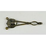 A Victorian silvered brass skirt lifter with anchor and laurel leaf motif.