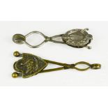 Two Victorian skirt lifters, one with horse shoe clip, the other depicting swan.