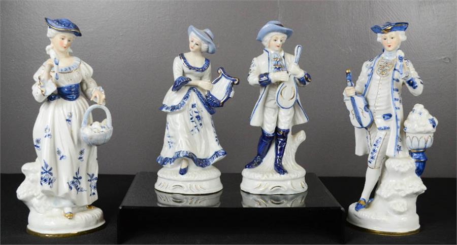 Two pairs of blue and white ceramic figures, in Victorian attire.