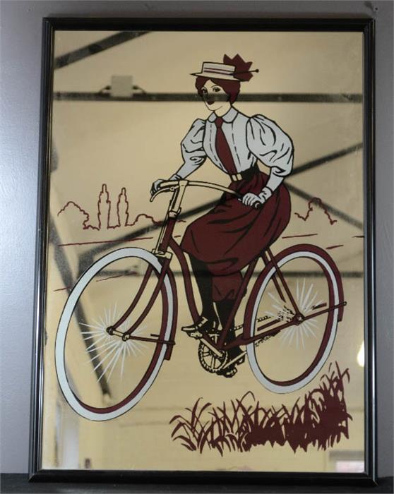 A French wall mirror depicting woman riding a bicycle.