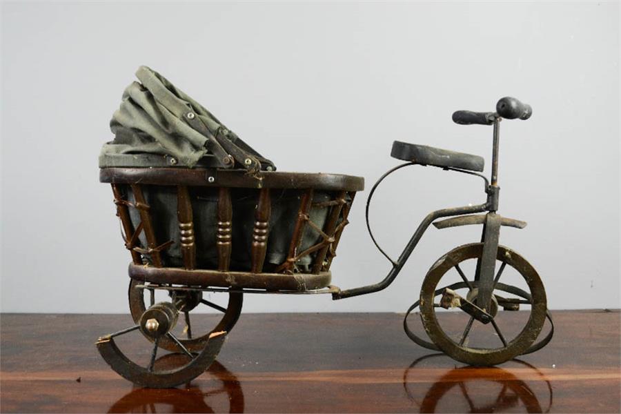 A wooden vintage model tricycle, with pram to the back, 29cm high.