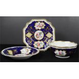 Three French porcelain hand painted bowl and dishes, on cobalt blue ground, gilt highlights, 22cm