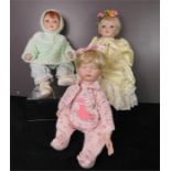 Three porcelain headed baby dolls, wearing hand made clothes.