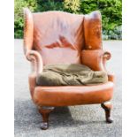 A leather wing back armchair.