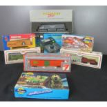 A model train control together with a group of model train carriages including Bachmann, in boxes.