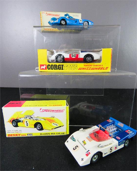 A Dinky 223 McClaren M8A CAN AM, a Dinky 200 Matra 630, Porsche Carrera 6 Corgi, all boxed.