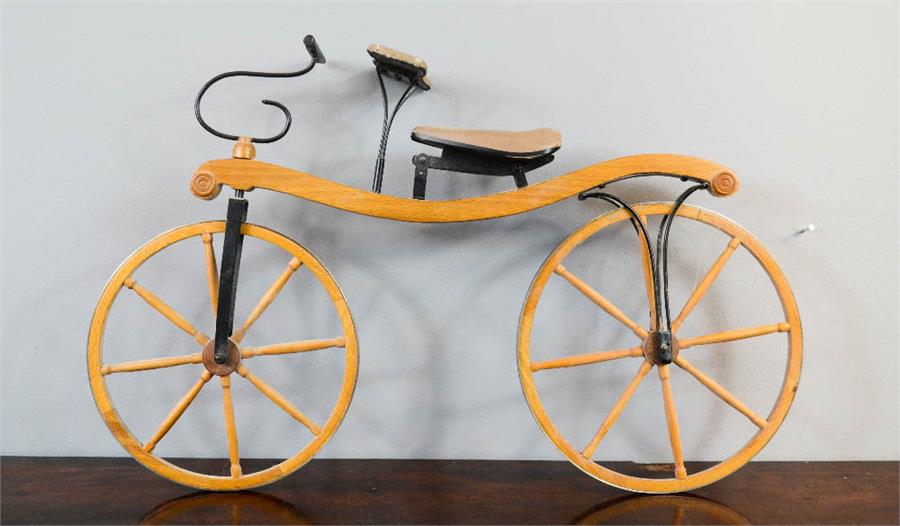 A wooden model Victorian boneshaker bicycle