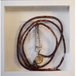 A Victorian skirt lifter, scallop motif with original cord, framed.