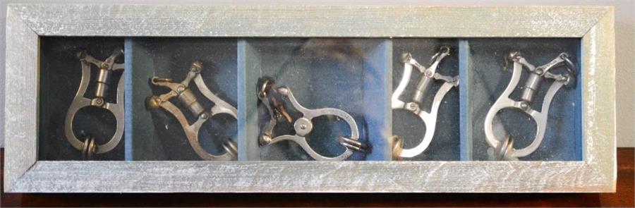 A group of five steel skirt lifters, one Shakespeare patent, in a presentation box.