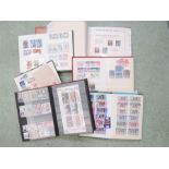 A group of six stamp albums, including Worldwide stamps.