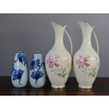 A pair of ceramic floral vases, together with a pair of blue and white ceramic vases.