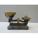 A vintage set of scales together with the weights.