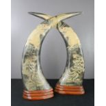 A pair of Chinese carved horns depicting tiger and dragons.