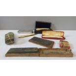 A group of vintage razors, cut throats, some boxed, a strop and others.