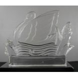 A pressed glass paperweight / ornament depicting a swan.