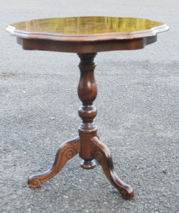 A mahogany inlaid tripod occasional table.