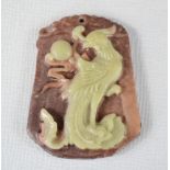 A Chinese jade carved pendant depicting a pheonix.