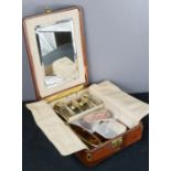 A leather travelling vanity case, by Bruford & Son, Exeter, the compartments containing silver