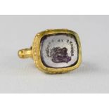 An early intaglio, depicting a rabbit and inscribed, set in a later gilt metal fob, possibly