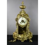 A French brass mantle clock, with Roman Numeral dial, and key, 42cm high.