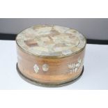 A Chinese box with mother of pearl decorated top, engraved with detail, 9 cm by 18 cm diameter.
