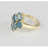 A 9k gold and aquamarine ring, the six stones set in the form of a diamond.