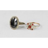 Two silver dress rings, one set with red paste stones in square form, size O/P the the other an oval