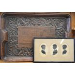 An oak carved antique tray together with a set of three silhouette portraits.