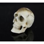 A carved bone miniature skull.