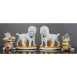 A pair of miniature porcelain dogs, and comical cats, tallest 6cm high.