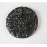 A Chinese black jade pendant carved with dragon design.
