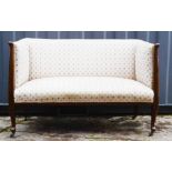 An Edwardian two seater settee, floral upholstered.
