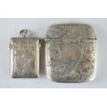 Two silver vesta cases, one with match striker to the base, and chased floral engraving, 2.04toz.