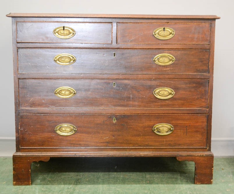 A 19th century mahogany chest of drawers, two over three long graduate drawers raised on bracket