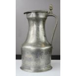 An early pewter flagon with protruding thumb piece to the cover.