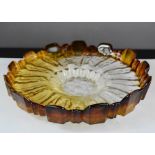 A 1950s Finnish Humphilla art glass ice dish with blocked rim and textured base in amber and
