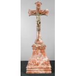 An early 20th century crucifix in bronze raised on a marble base.