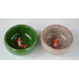 A pair of Chinese tea bowls with inset raised goldfish.
