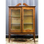 An Art Nouveau inlaid mahogany display cabinet.