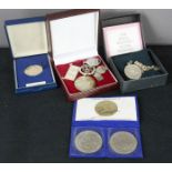 A group of silver commemorative coins, keyring, pendants, and necklace by Franklin Mint; boxed