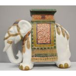 An Indian porcelain table stand in the form of an elephant.47cm high, 56cm long, 24cm wide approx.