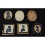 A group of silhouettes in Victorian frames, and two oval miniature frames.