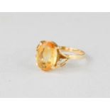An 18ct gold and citrine ring, the oval cut citrine in an open work stylised leaf setting, size O,