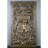 An Italian bronze plaque, cast with cherubs above dolphins, 49 by 27cm.