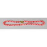 A South Sea pink coral bead necklace.